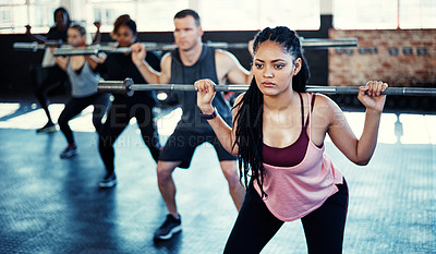 Buy stock photo Shot of a fitness group using steel bars in their session at the gym