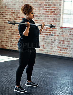 Buy stock photo Shot of a young woman working out in a gym