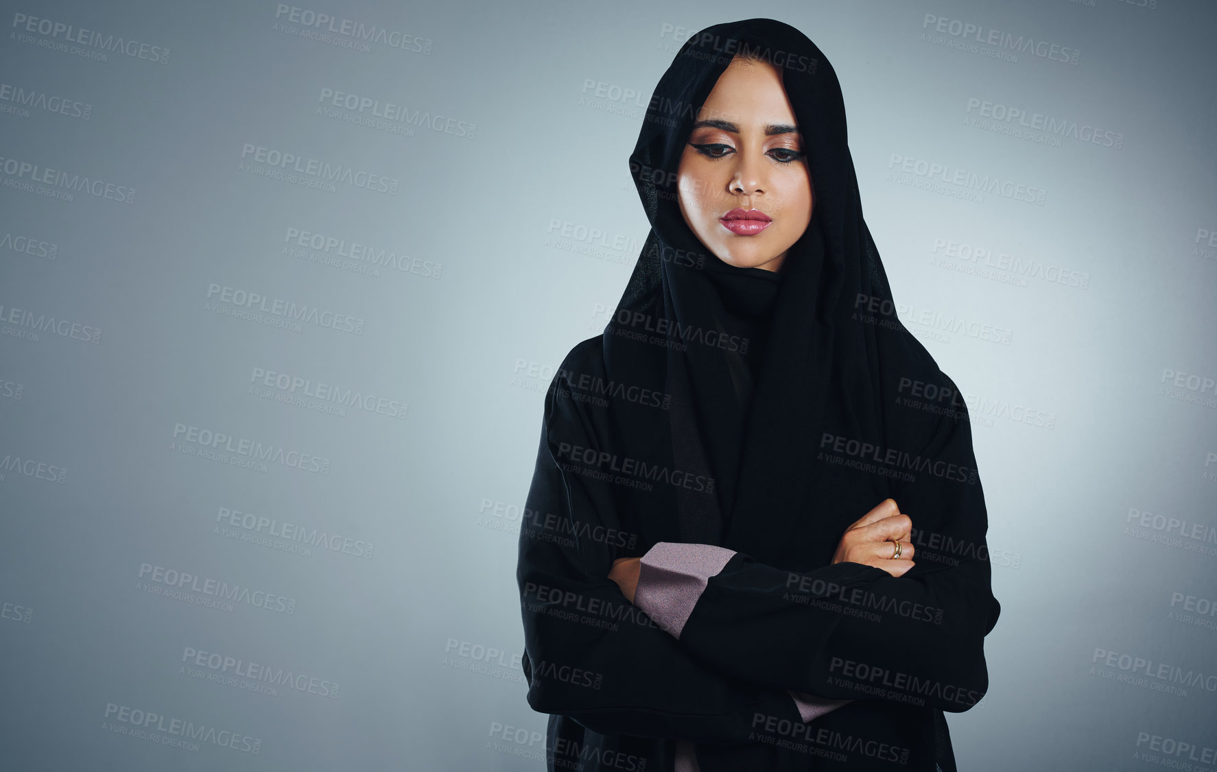 Buy stock photo Studio shot of a young muslim businesswoman against a grey background