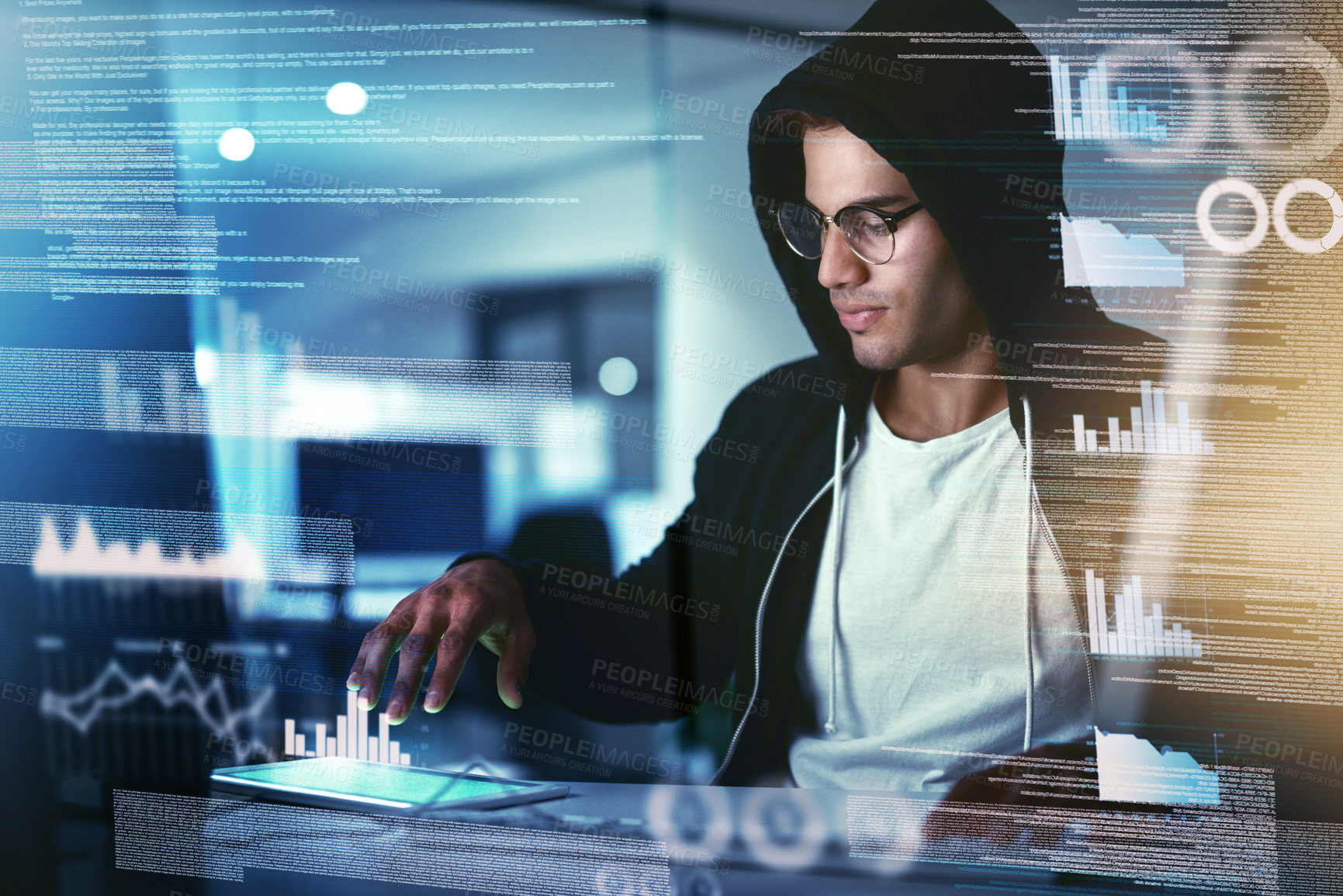 Buy stock photo Shot of a young hacker cracking a computer code in the dark