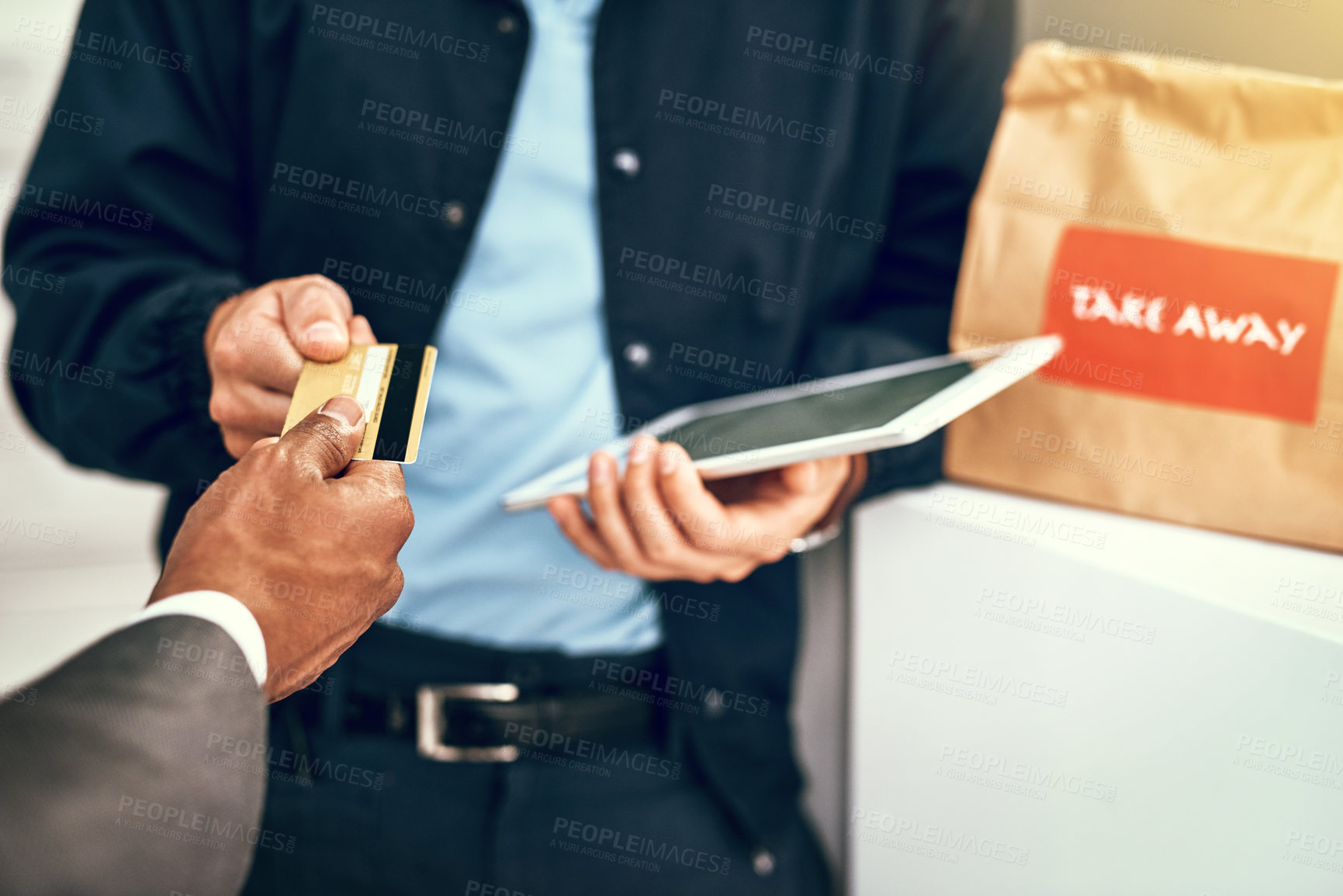 Buy stock photo Closeup shot of a businessman using a credit card to pay for a delivery made by a courier