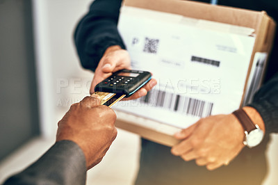 Buy stock photo Closeup shot of a businessman using a credit card to pay for a delivery made by a courier