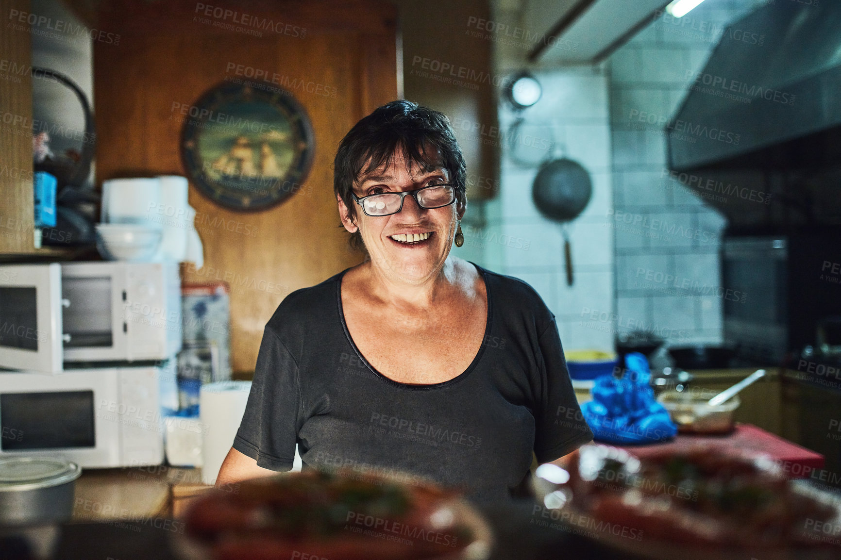 Buy stock photo Cropped shot of a mature woman working in a restaurant