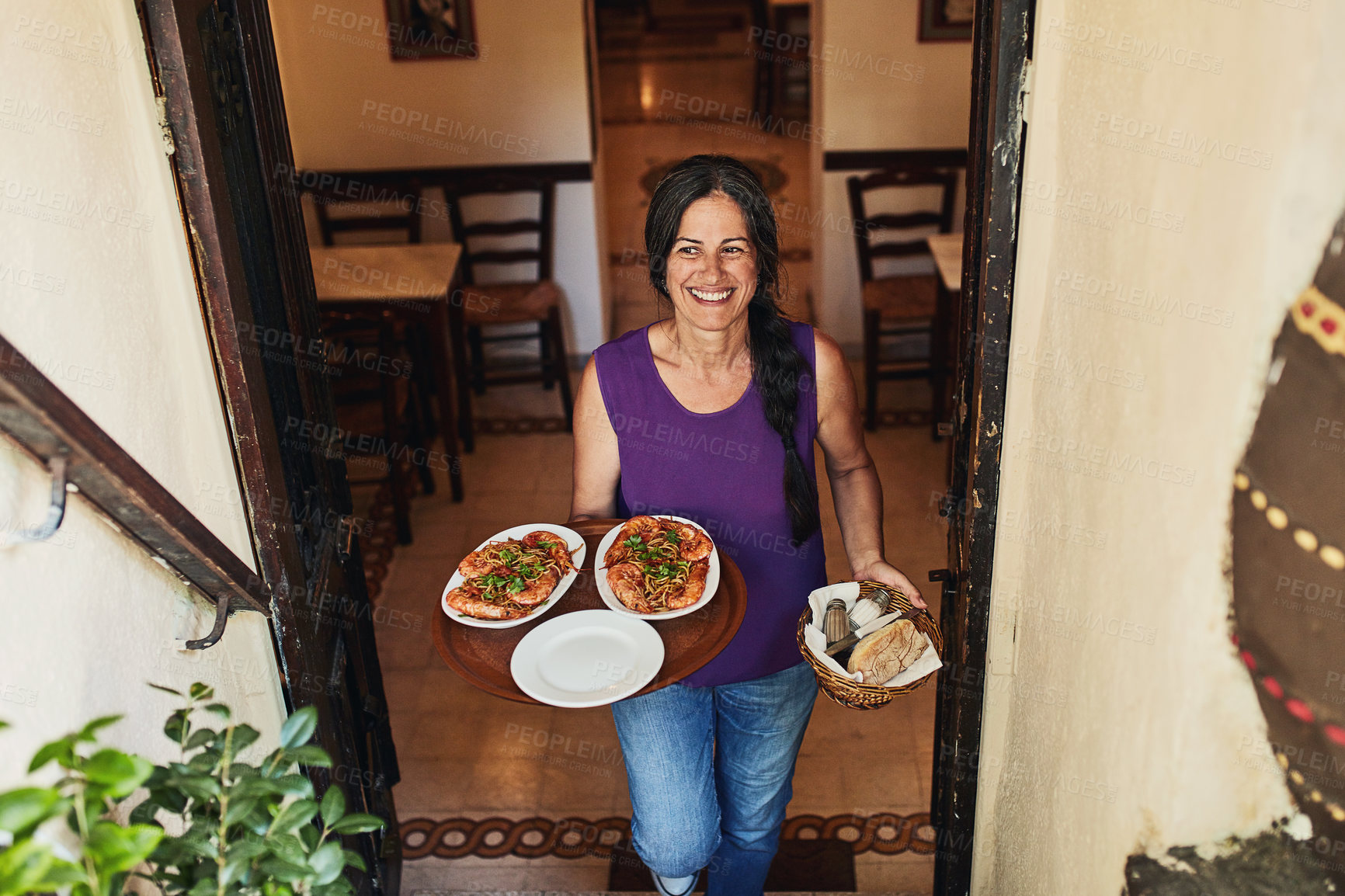 Buy stock photo Cropped shot of a mature woman working in a restaurant