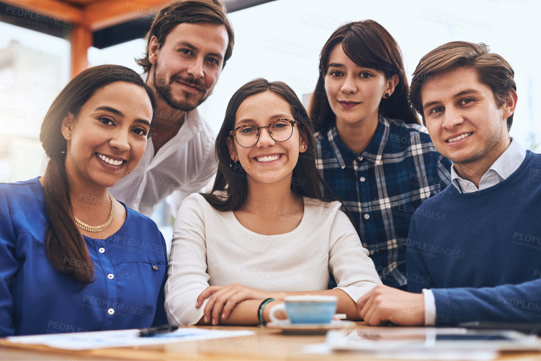 Buy stock photo Portrait of a cheerful creative business team having a meeting and drinking coffee while looking at the camera outside