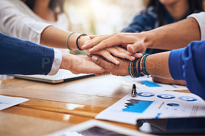 Buy stock photo Cropped shot of a group of unrecognisable people's hands forming a huddle together around a table outside