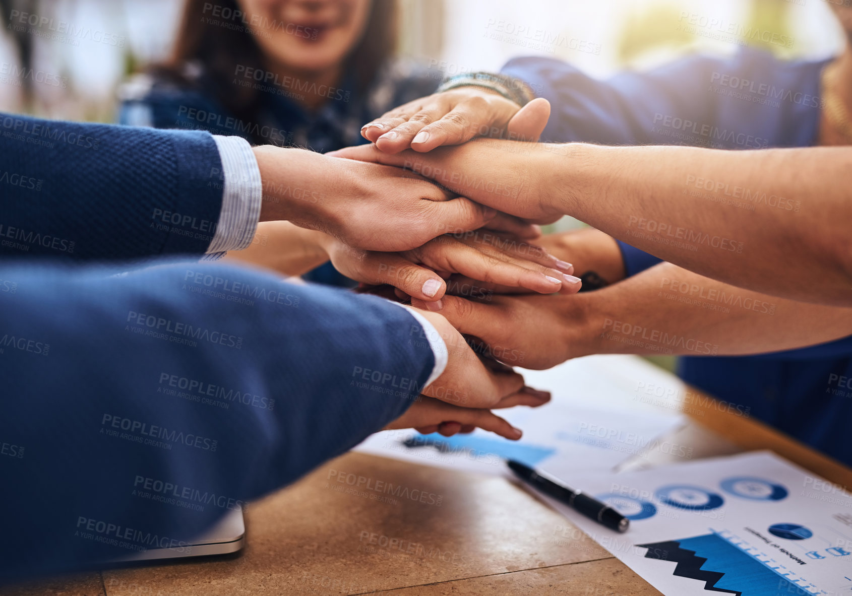 Buy stock photo Cropped shot of a group of unrecognisable people's hands forming a huddle together around a table outside