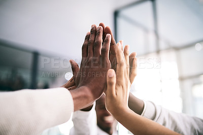 Buy stock photo Shot of a motivated group of unrecognizable businesspeople's hands coming together for a high five