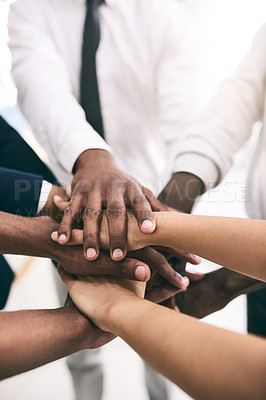 Buy stock photo Shot of a motivated group of unrecognizable businesspeople's hands forming a huddle