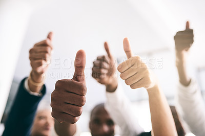 Buy stock photo Shot of a motivated group of unrecognizable businesspeople raising their hands and showing thumbs up