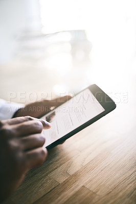 Buy stock photo Shot of a unrecognizable person browsing on their digital tablet