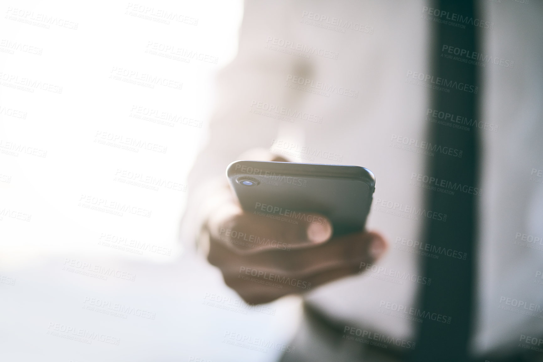 Buy stock photo Shot of a unrecognizable business person holding a cellphone and writing a message