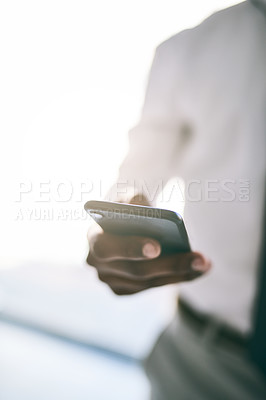 Buy stock photo Shot of a unrecognizable business person holding a cellphone and writing a message