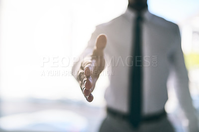 Buy stock photo Shot of a unrecognizable business person stretching out their hand for a handshake