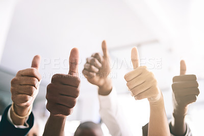 Buy stock photo Shot of a motivated group of unrecognizable businesspeople raising their hands and showing thumbs up