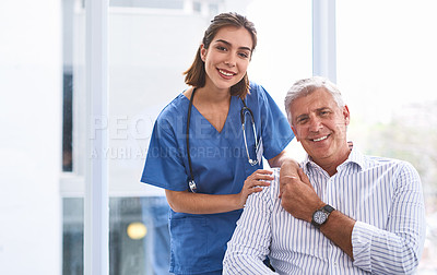 Buy stock photo Portrait of a cheerful young female doctor holding a patient's hand while looking at the camera inside a clinic
