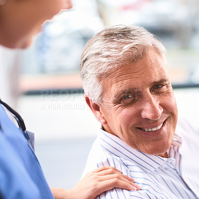 Buy stock photo Portait of a cheerful mature male patient's shoulder being held by a doctor inside of a clinic