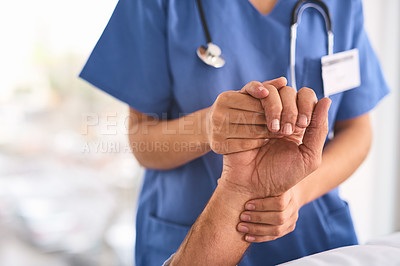 Buy stock photo Shot of a unrecognisable person's hand being held by a doctor inside a medical clinic