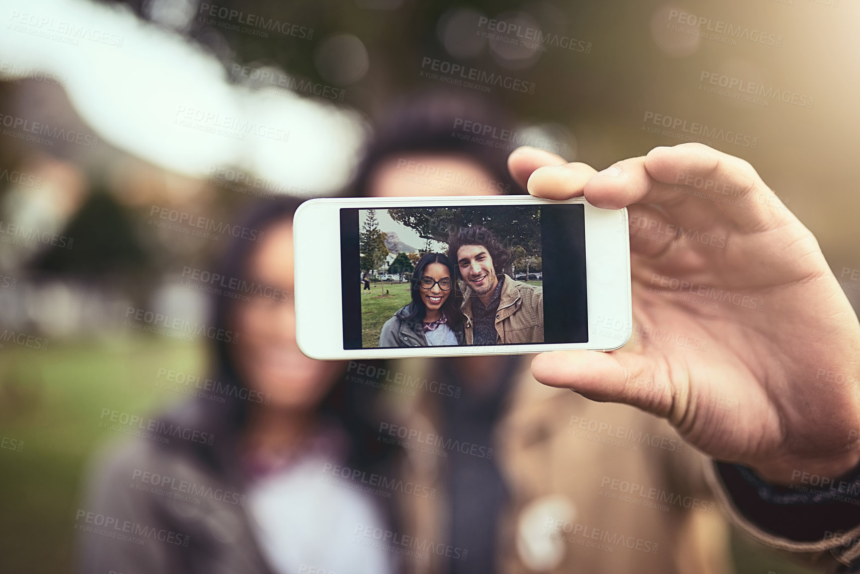 Buy stock photo Couple, selfie and outdoor in portrait with phone screen at park with app, bonding or smile in spring on holiday. Interracial love, man and woman with photography, memory and social media in Toronto