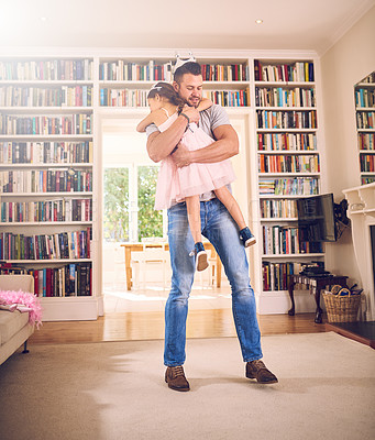 Buy stock photo Shot of a father hugging his little daughter at home