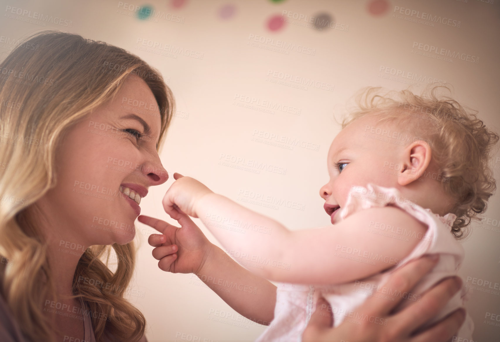 Buy stock photo Shot of a young woman bonding with her baby girl at home