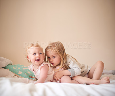 Buy stock photo Shot of two adorable sisters bonding together at home