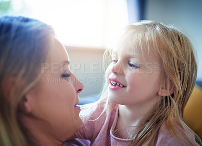 Buy stock photo Shot of an adorable little girl bonding with her mother at home