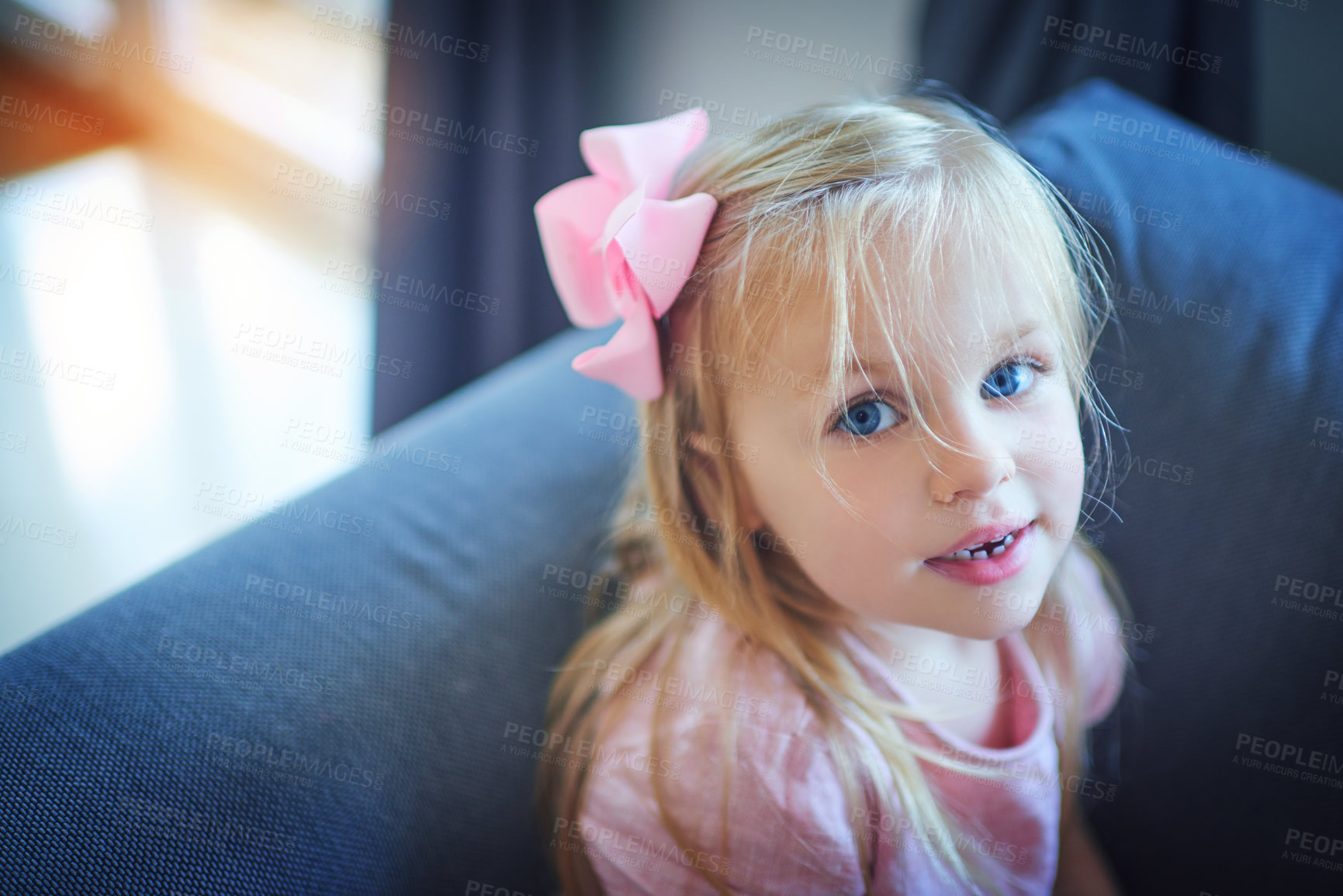Buy stock photo High angle portrait of an adorable little girl sitting on the sofa at home
