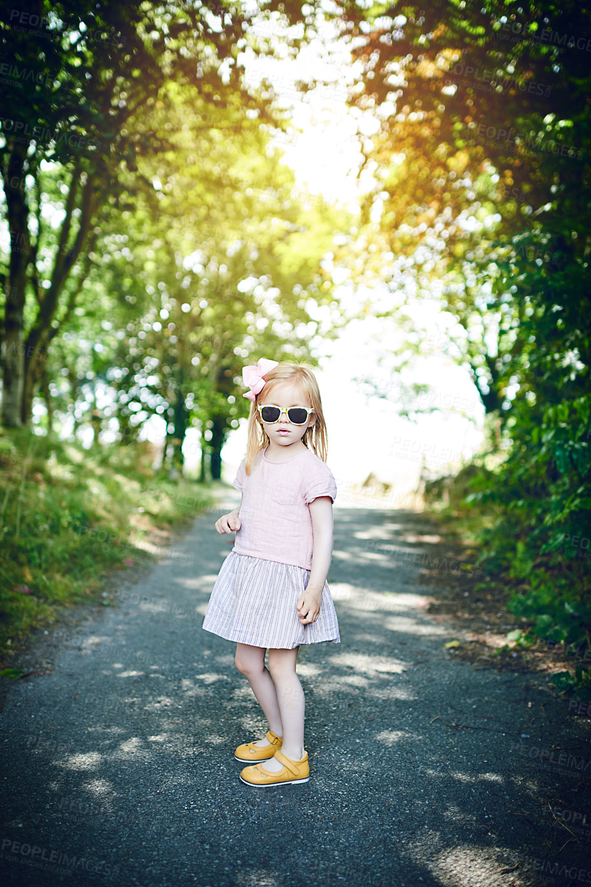 Buy stock photo Portrait of an adorable little girl standing outdoors