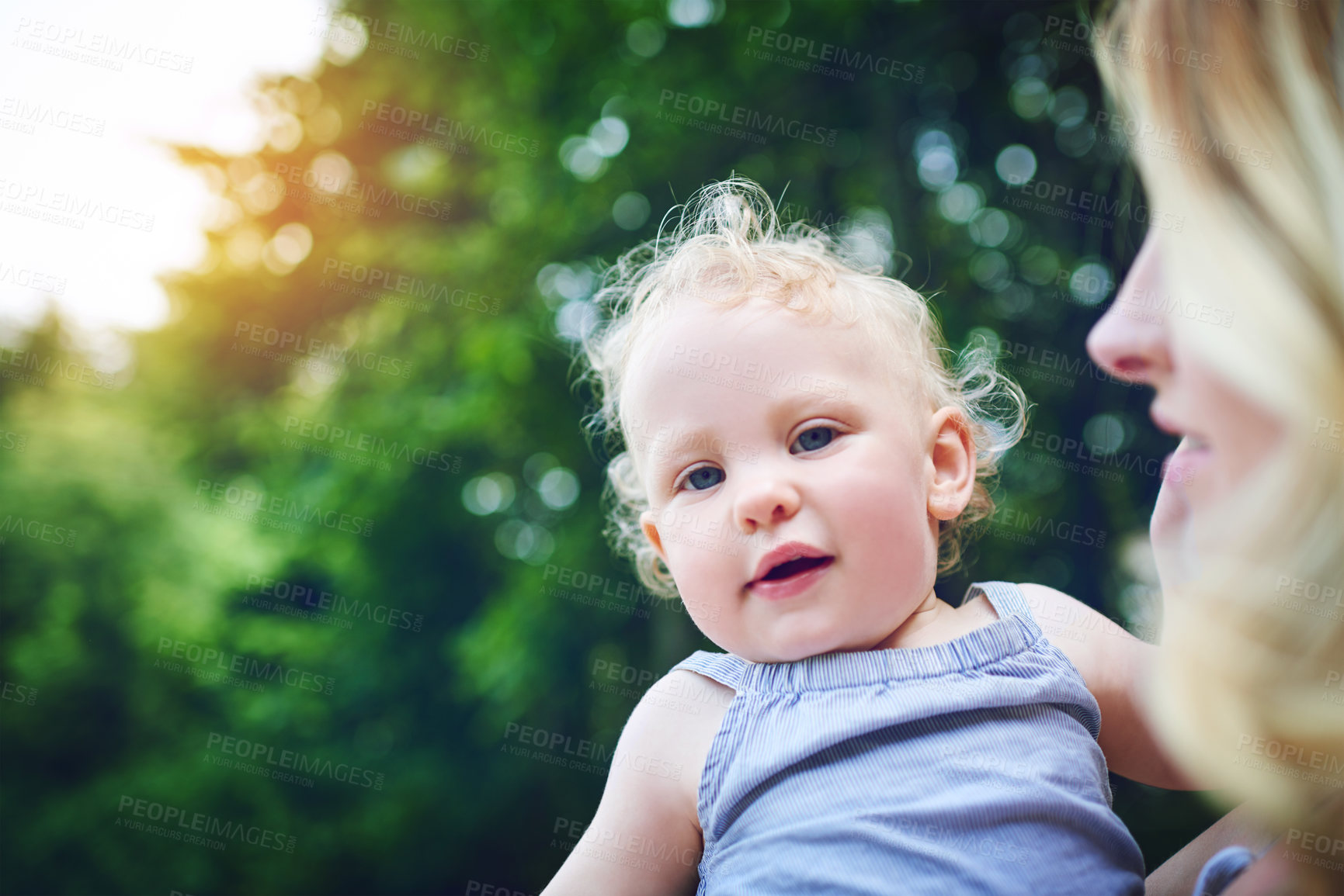 Buy stock photo Shot of an adorable baby girl bonding with her mother during a day outdoors