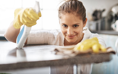 Buy stock photo Happy woman, kitchen counter and cleaning bottle in house for hygiene, housework and housekeeping service for safety. Chores, spray and maid with cloth on table to wipe dirt, dust or bacteria in home