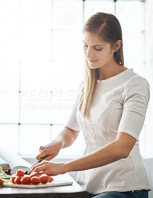 Buy stock photo Woman, knife and vegetables with food in kitchen for lunch, vegan meal and healthy diet with nutrition. Female person, tomato and hungry for salad in home with natural light, dinner and recipe book