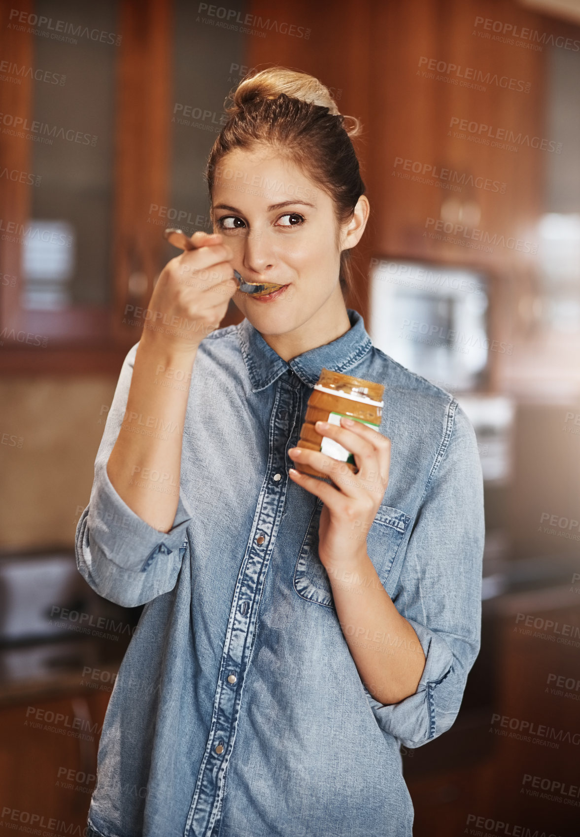 Buy stock photo Happy woman, container and eating peanut butter in kitchen with spoon, vegan diet and nutrition in home. Female person, health and snack in apartment for vitamins, breakfast and energy in morning