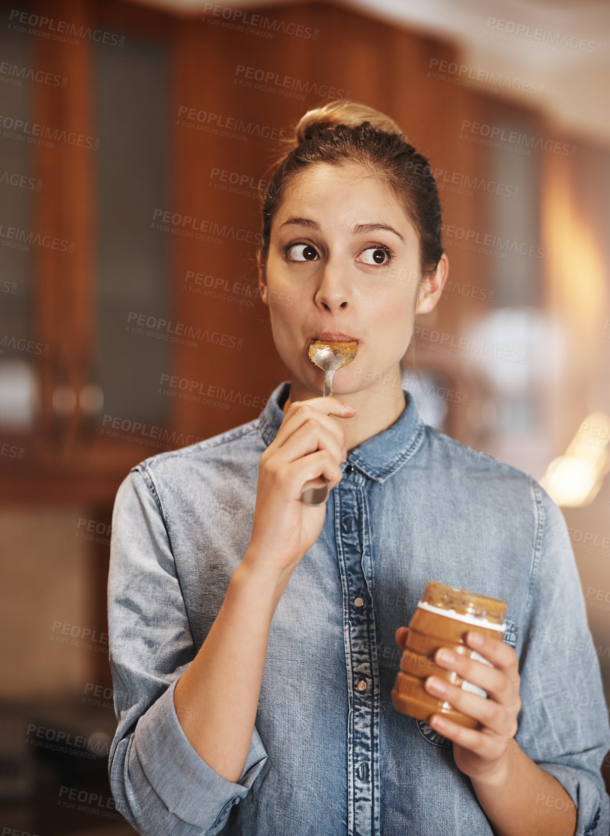 Buy stock photo Woman, nutrition and peanut butter in home for diet. breakfast and eating fiber or vitamins. Female person, hungry and glass container for food, meal and jar of minerals for vegan treat or wellness