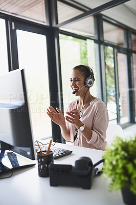 Buy stock photo Shot of a cheerful businesswoman talking to a customer using a headset while clapping her hands