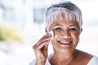 Buy stock photo Shot of a mature woman going through her beauty routine at home