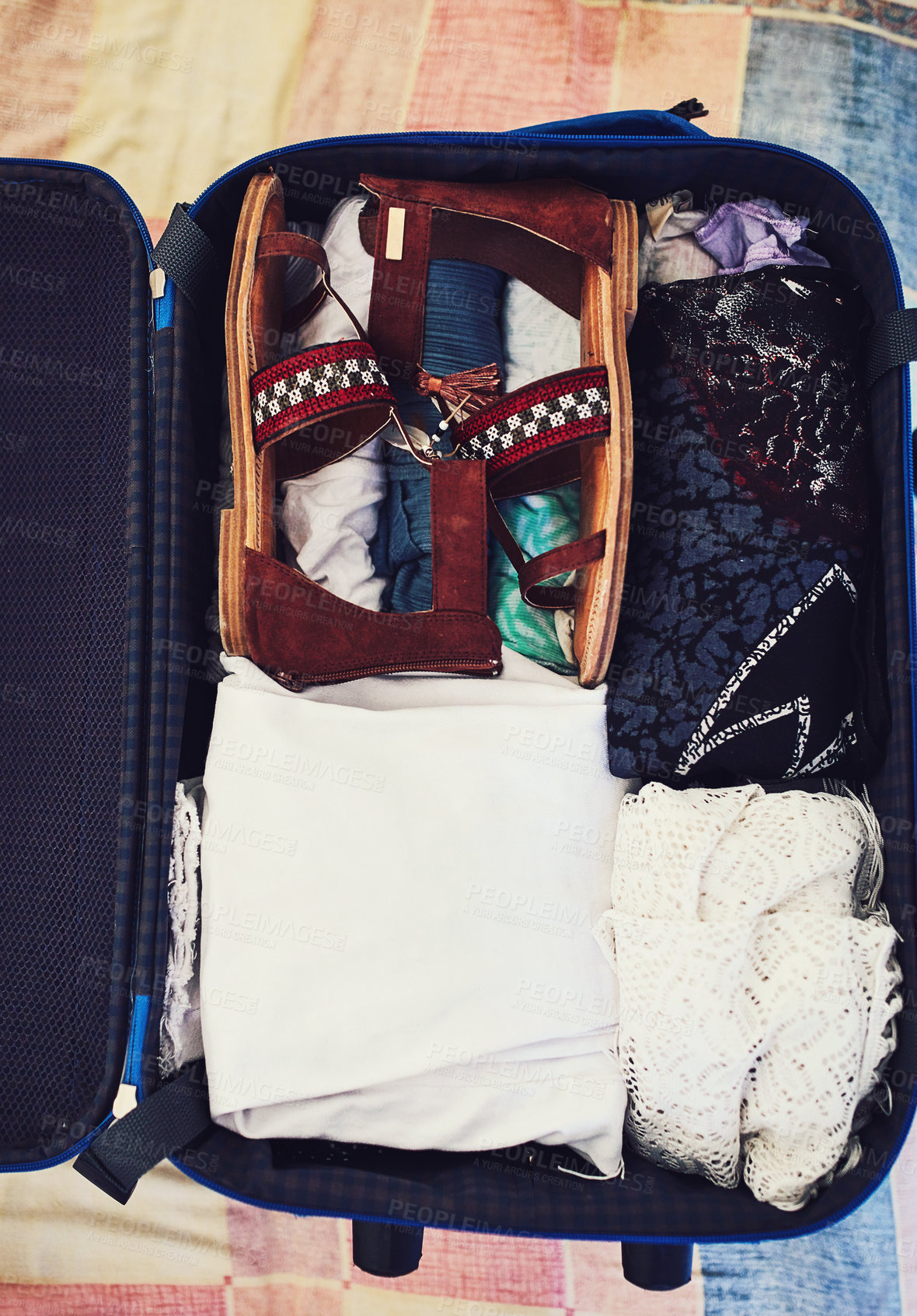 Buy stock photo High angle shot of a suitcase packed with clothing
