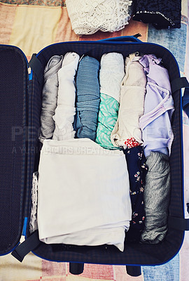 Buy stock photo High angle shot of a suitcase packed with clothing