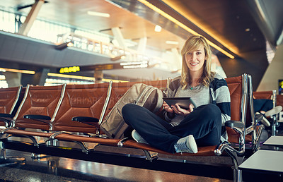 Buy stock photo Shot of a young woman using a tablet in an airport