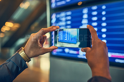 Buy stock photo Shot of an unrecognizable man taking a picture of a board in an airport