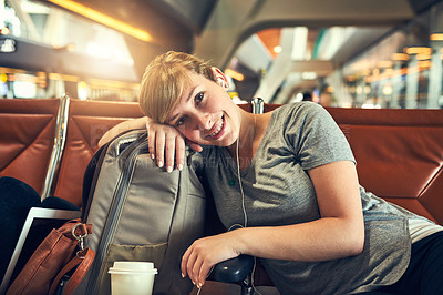 Buy stock photo Shot of a young woman resting before her flight