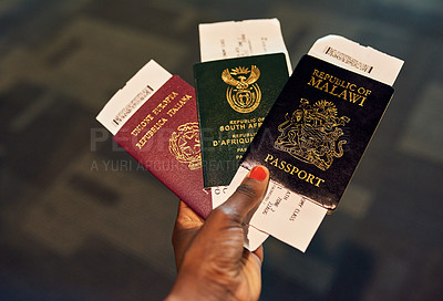 Buy stock photo Shot of an unrecognizable person holding passports indoors