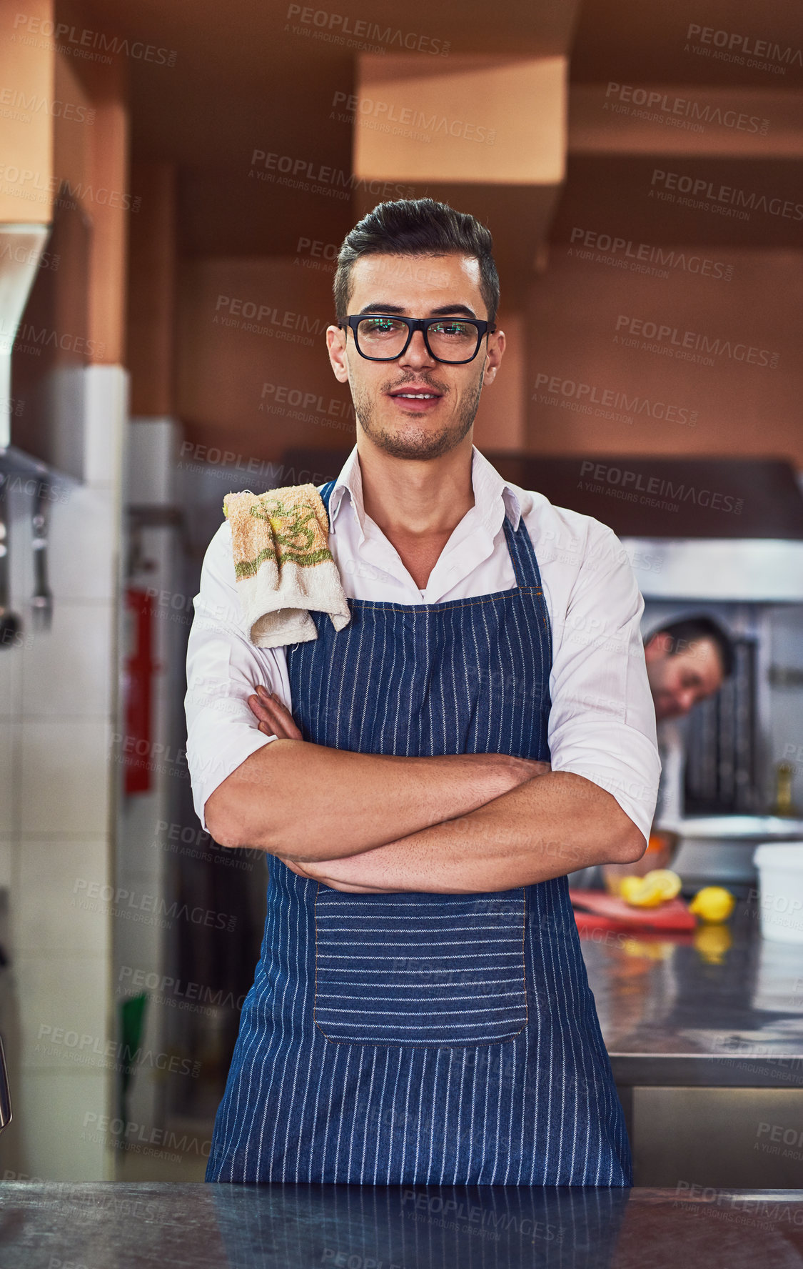 Buy stock photo Kitchen, portrait and man with confidence for cooking, meal preparation and expert for culinary with smile. Restaurant, male chef and pride by counter for hospitality, customer service and business