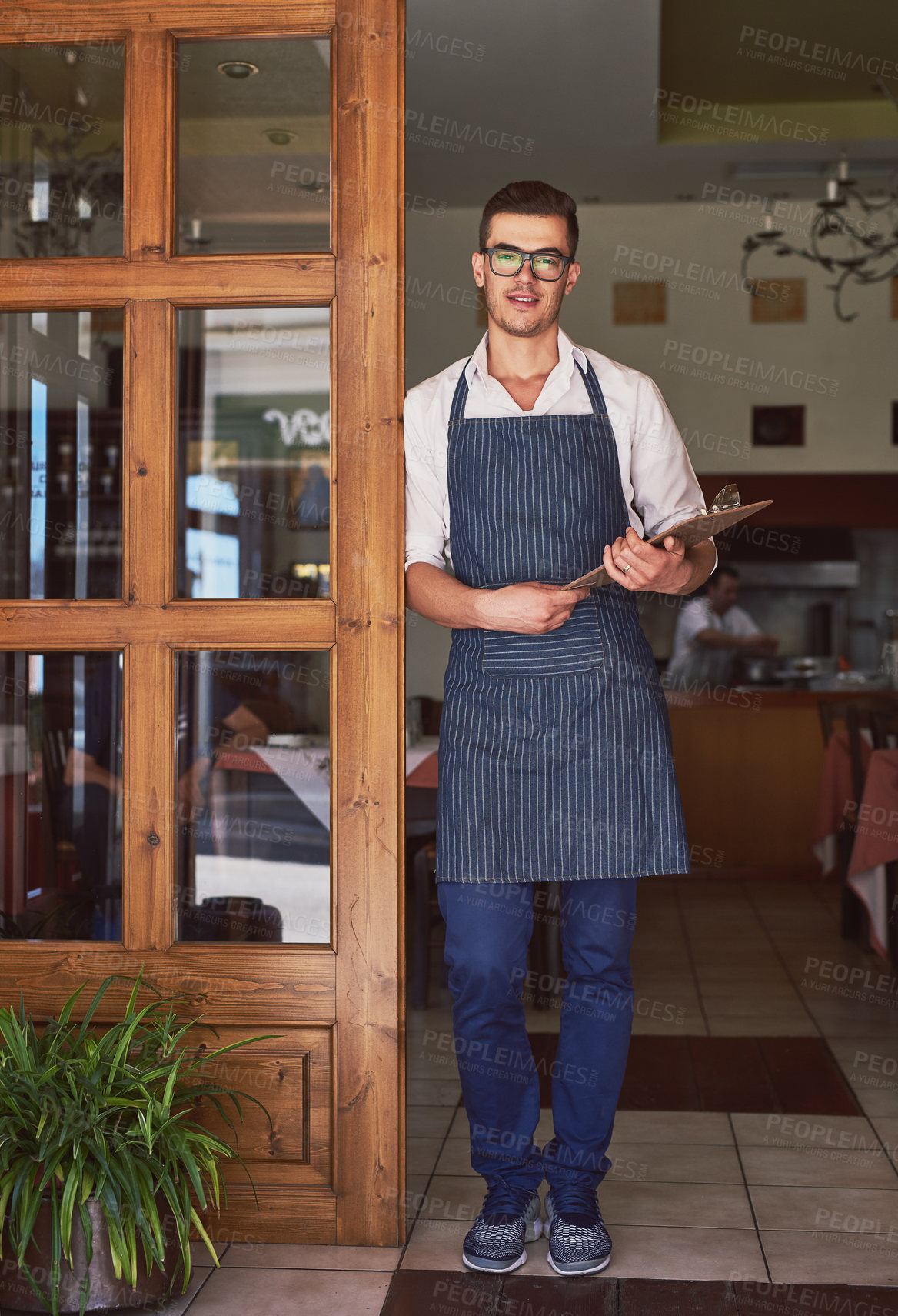 Buy stock photo Portrait, man and waiter with clipboard at restaurant doorway for order in cafe. Startup, confident barista and small business owner in glasses with checklist for inventory or stock at coffee shop