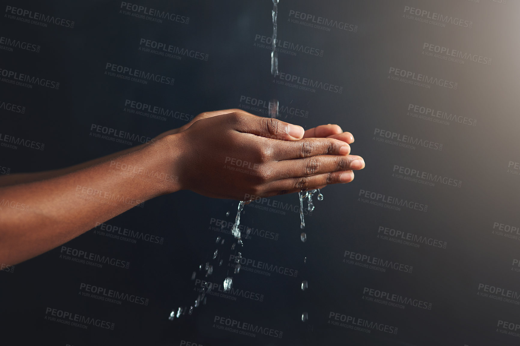 Buy stock photo Washing hands, water and person cleaning palm for hygiene isolated in a dark or black studio background. Stream, splash and hand clean for wellness or hydration with germ protection or bacteria