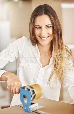 Buy stock photo Cropped portrait of an attractive young woman sealing a box on moving day