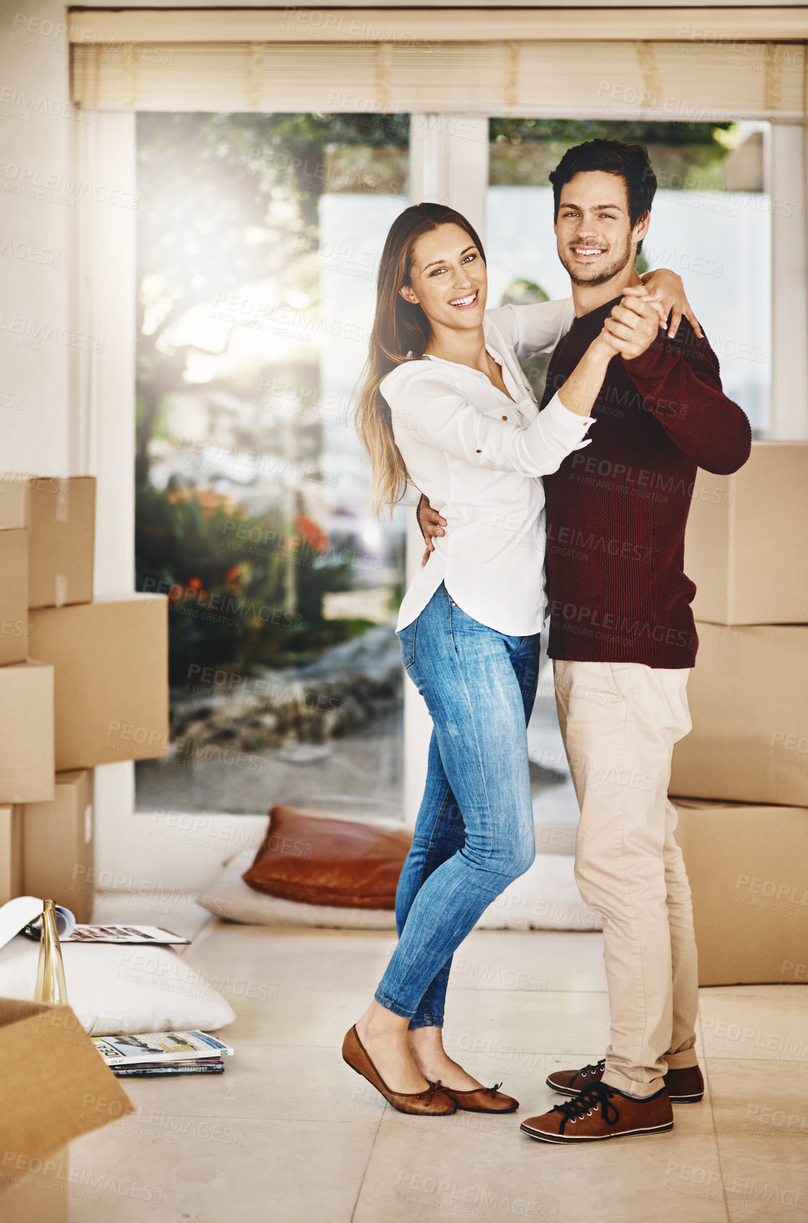 Buy stock photo Full length portrait of an affectionate young couple dancing while moving into a new home