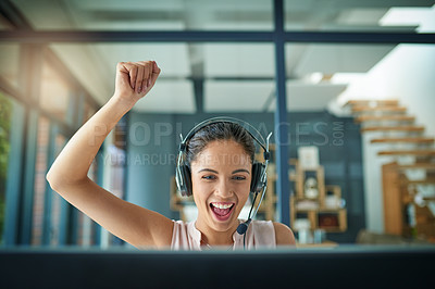 Buy stock photo Shot of a young woman working in a call center and cheering