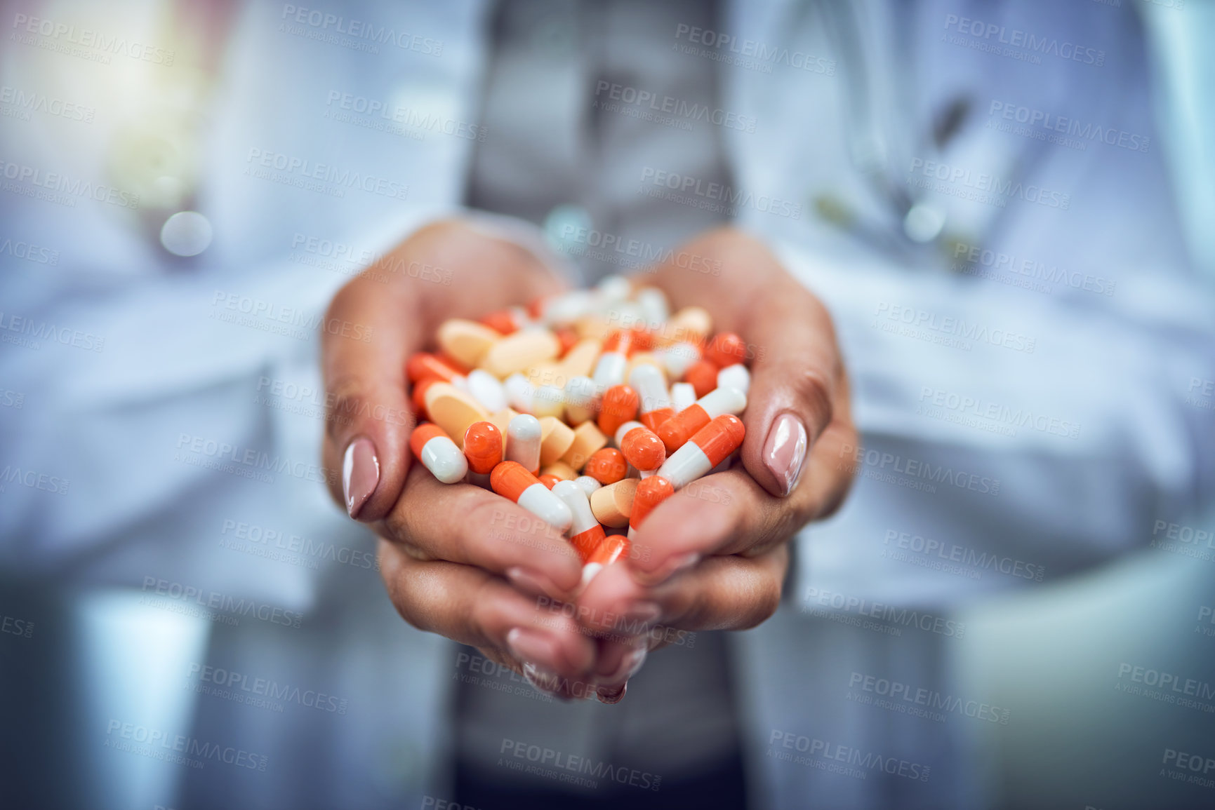 Buy stock photo Closeup shot of an unidentifiable doctor holding a variety of pills in her hands