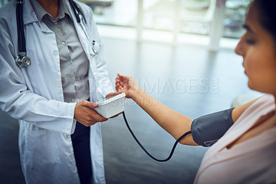 Buy stock photo Closeup shot of a doctor checking a patient's blood pressure